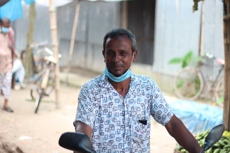 Bangladesh, Rangpur- July 03, 2021. A person is standing with open his Covid-19 maskのeditorial素材