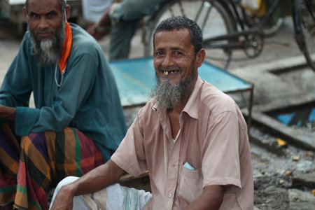 Bangladesh, Rangpur- July 03, 2021. An old man is sitting in the market and he is very happyのeditorial素材