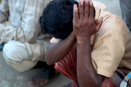 Bangladesh, Rangpur- July 12, 2021. An old man sitting in his shop with upset. his behind background blur.のeditorial素材