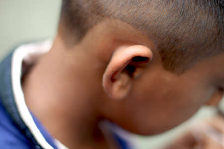 Bangladesh, Rangpur- July 02, 2021. A part of a boy's ear and his behind background blurのeditorial素材