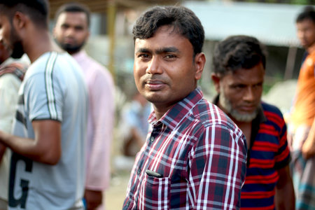 Bangladesh, Rangpur- July 12, 2021. A young man standing on the market. his behind background blur.のeditorial素材