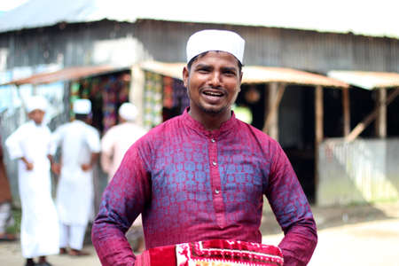 Bangladesh, Rangpur- July 21, 2021. A boy is happily standing in the street after Eid prayers and the background blur.のeditorial素材