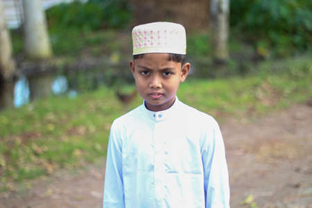 Bangladesh, Rangpur- July 21, 2021. One little kid is very happy and the background behind is blurry.のeditorial素材