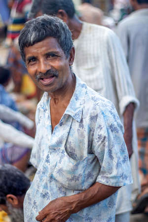 Bangladesh, Rangpur- August 31, 2021. A old man stands in the local market and looks at the camera. the background blurのeditorial素材