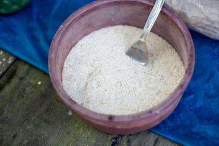 There are many small grains with medicinal properties in a plate and background blurの写真素材