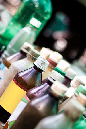 An old drugstore has many small bottles of medicine in a row and the background blurの写真素材