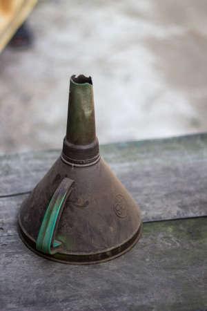 an old dirty oil pourer on a table on the road side and the background blurの写真素材
