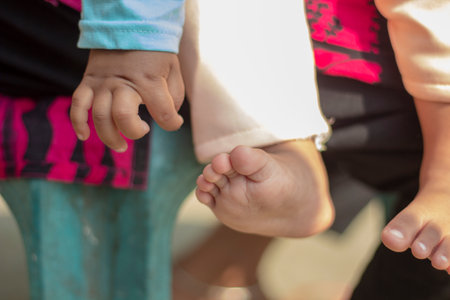 there is child leg and hand and the background is blurredの写真素材