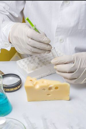 Food safety laboratory procedure, lab assistant analysing fruits from the marketの写真素材