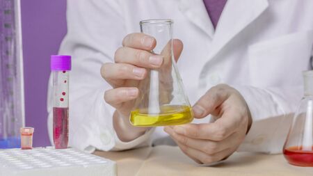 Female laboratory assistant with chemical experiment in scientific laboratory.の写真素材
