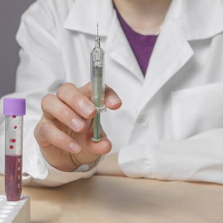 Laboratory research. Female lab hands hold syringe and injection.の写真素材