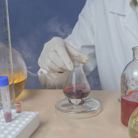 Medical technician heats in vitro material for analysis.の写真素材