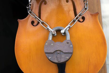 Soul of the music stopped concept: classical violin locked with chainの写真素材