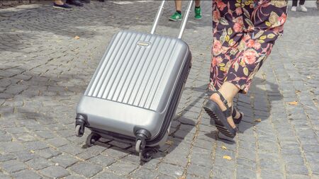 Traveling tourist walking with luggage along an old street. Lifestyle Travelの写真素材