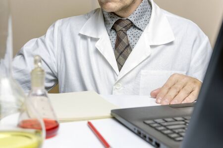 Close up male doctor or medical student in lab, electronic records system.の写真素材