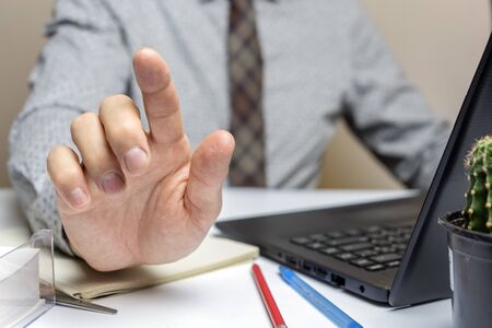 Businessman shows his hand with index finger. Close up.の写真素材