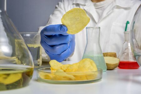 Food safety expert checking potato chips in the laboratoryの写真素材