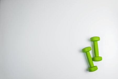 small green dumbbells, isolated in white background.の写真素材