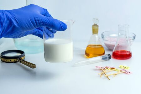 Quality control expert examining milk in the laboratoryの写真素材