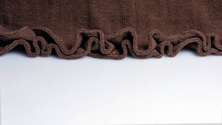 edge of a knitted wool skirt on a white background