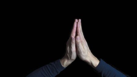 Man hands praying in dark backgroundの写真素材