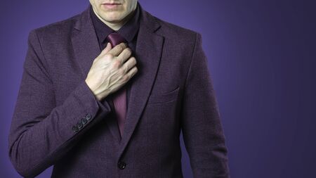 Photo close up of businessman in purple suit confident on dark blue background.の写真素材