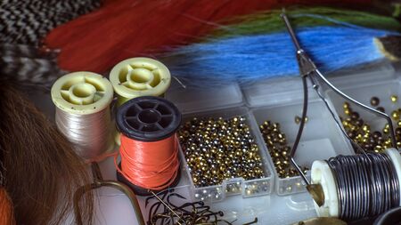 Photo closeup set of different accessories for knitting flies for fly fishingの写真素材
