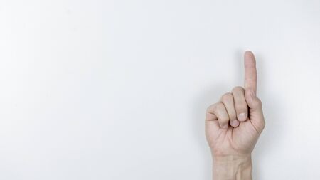 Photo Man pointing at something on white background, closeup of handの写真素材
