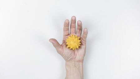 Photo Man's hand holds a mockup of coronavirus covid-19. The fight against coronavirus. Dirty hands...