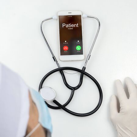 Top view, the doctor gives an online consultation to the patient.