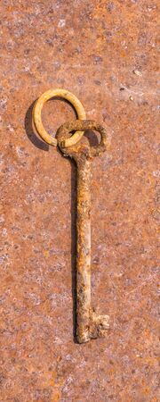 One photo old rusty keys on ring shot on steel textured background. Copy space.の写真素材