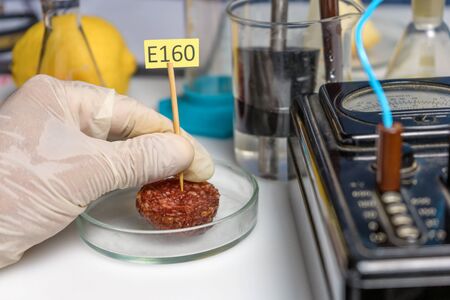 Healthy eating concept. The laboratory assistant s hand holds a tablet with the names of the...