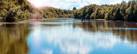 Beautiful sunny day on a calm river in summerの写真素材