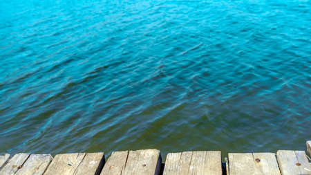 Photo wooden platform in front of lake in the morning.の写真素材