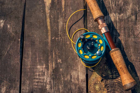Fly fishing rod with on wood backgroundの写真素材
