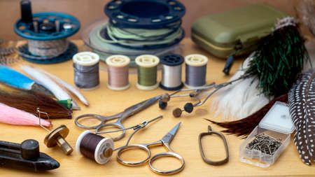 Photo Fly tying equipment and materials in preparation of making trout flies