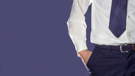 Photo Man in blue pants and white shirt close up on blue background
