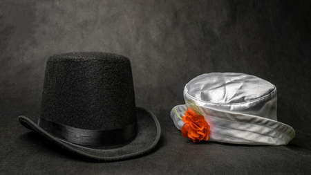 White womens hat and a black mens bowler hat on black background, symbolic photo for partnership and equality, gender conceptの写真素材