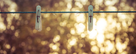 Two clothespins on a clothesline.