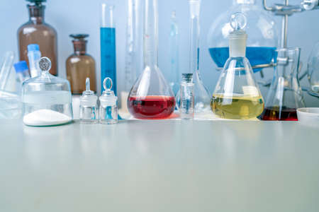 Flasks, test tubes and laboratory glassware with solutions of different colors on the table in the laboratory.の写真素材