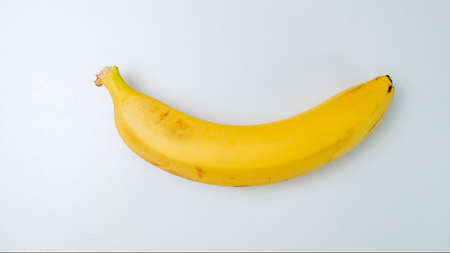 Single banana against white backgroundの写真素材