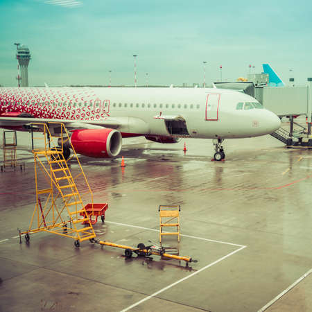 Photo Parked aircraft on an airport through the gate window.の写真素材