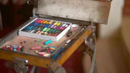 Photo Artist's workplace. Set of dry soft multicolored square pastels and easel.の写真素材