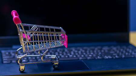 Photo Online shopping. A laptop and mini shopping cart and gadgets
