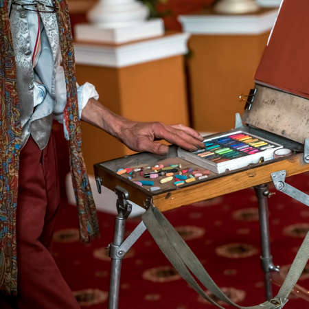 Photo Artist's workplace. Set of dry soft multicolored square pastels and easel.の写真素材