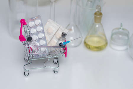 Photo shopping trolley with pills, on white background