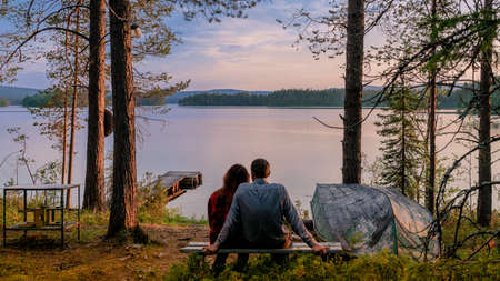 sunset under the tree at lakeの写真素材