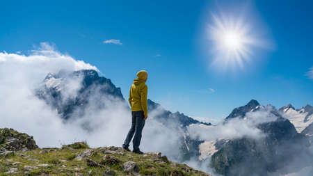 Photo Tourist on the peak of high rocks. Sport and active life conceptの写真素材