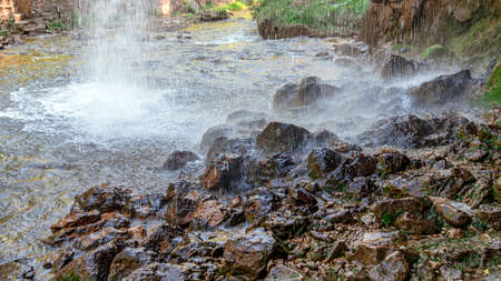 Beautiful waterfall on the mountain with blue sky shining sun. Waterfall in the mountains of the...