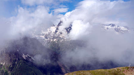 Summer Mountains Caucasus in the clouds. Beautiful snow-capped mountains.の写真素材